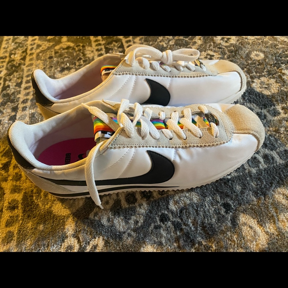 Mens size 10 rainbow, and white Nike shoes.